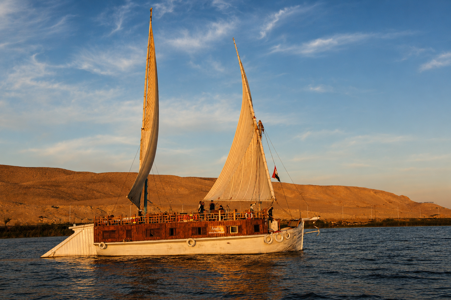 Traditional Dahabiya sailing on the Nile in Egypt Traditional Dahabiya sailing on the Nile in Egypt